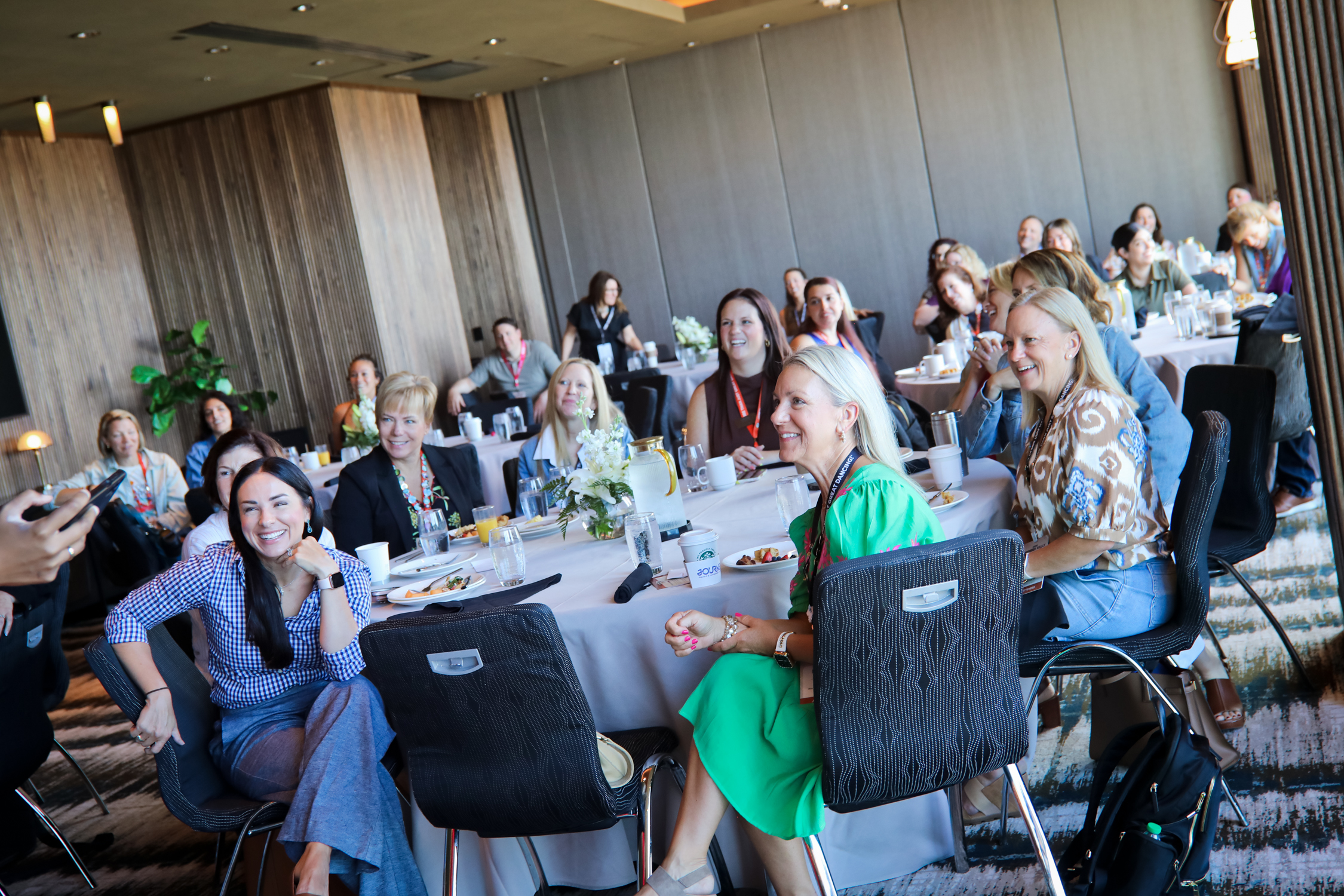 Studio owners working together at round tables during a workshop