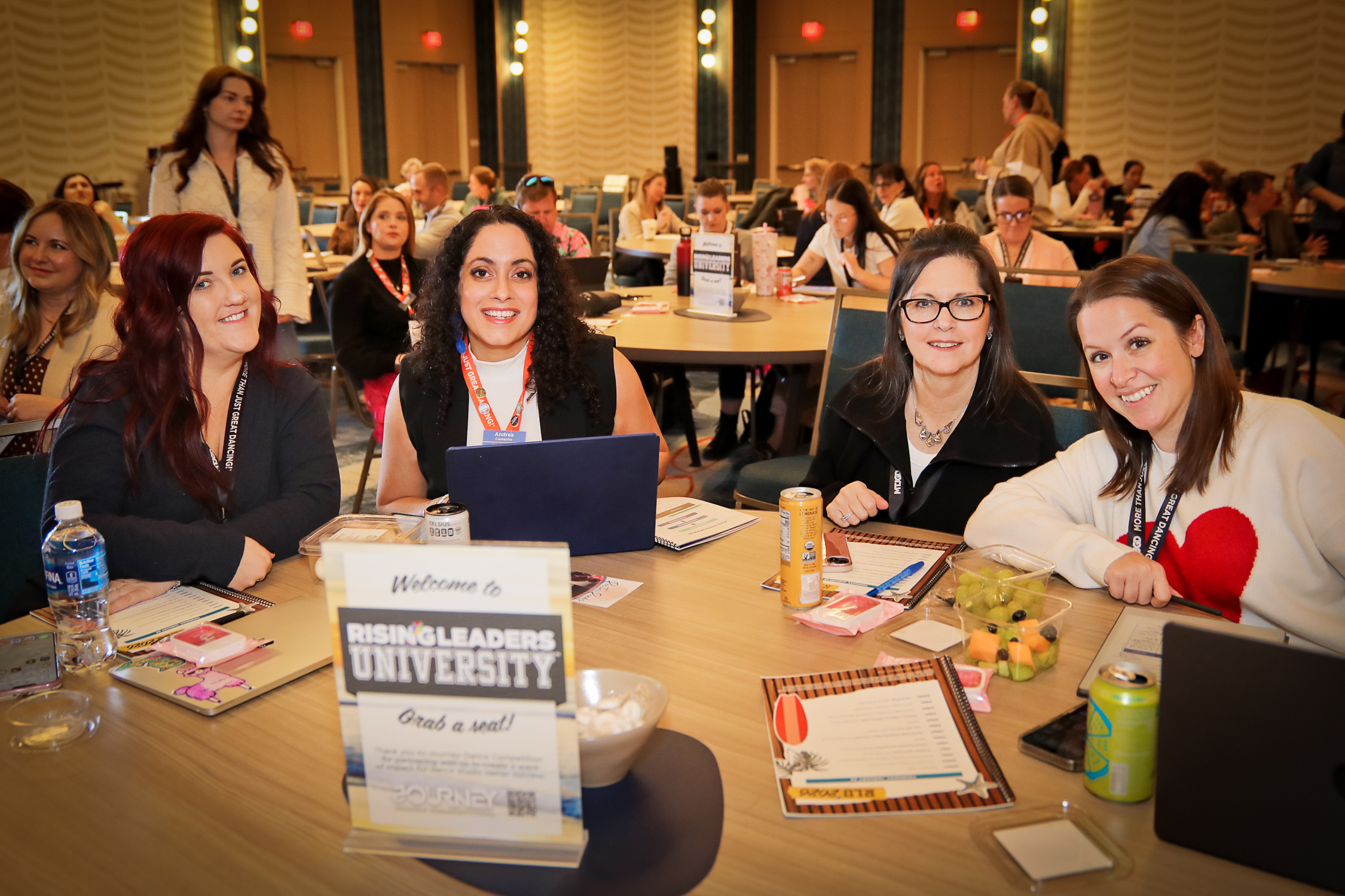 Studio team members seated together at a leadership training table
