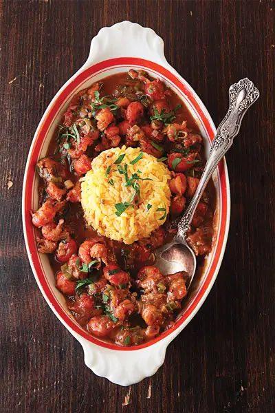 A Louisiana red beans and rice dish, plated with a silver spoon.