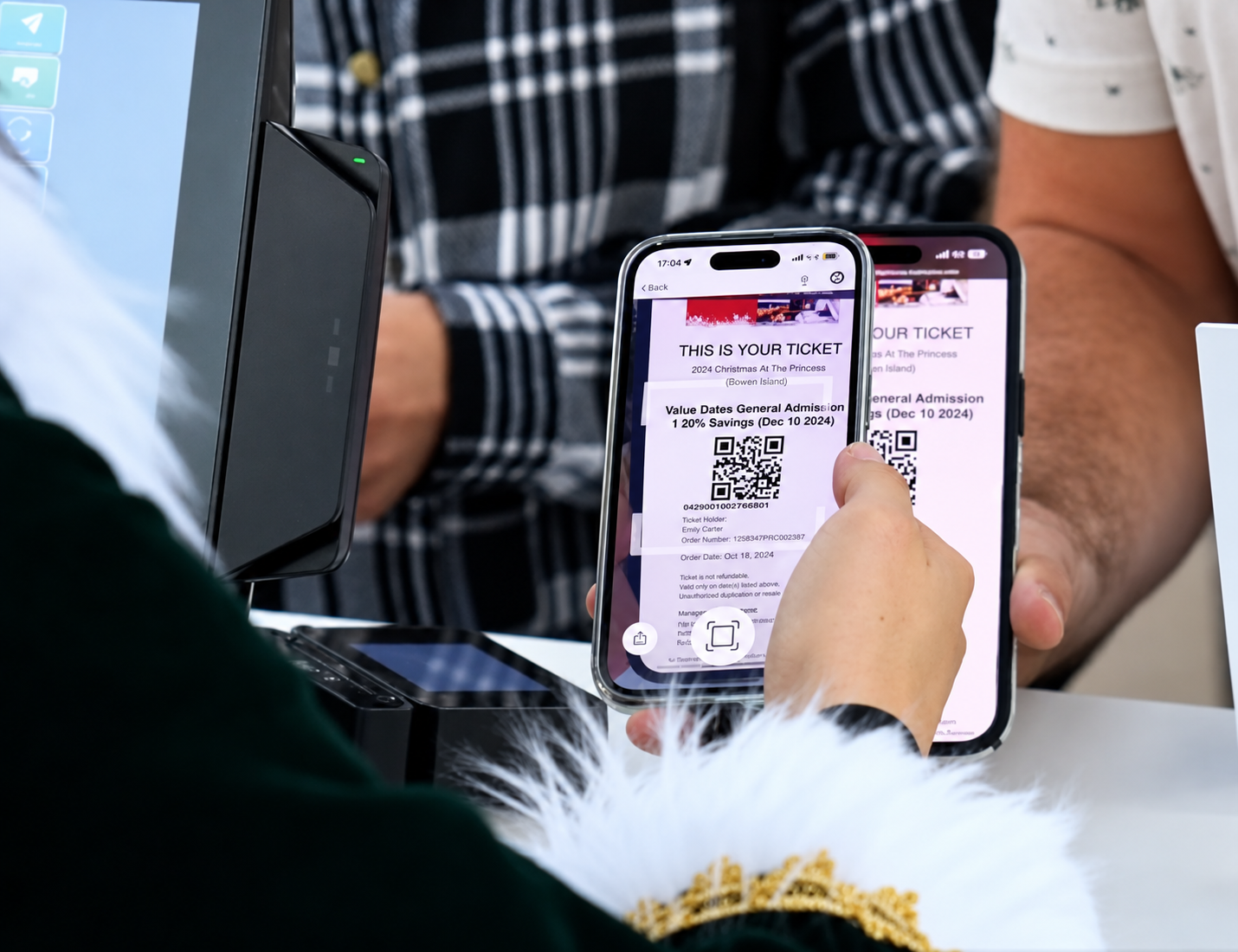 Guests buying tickets on a phone at the gate